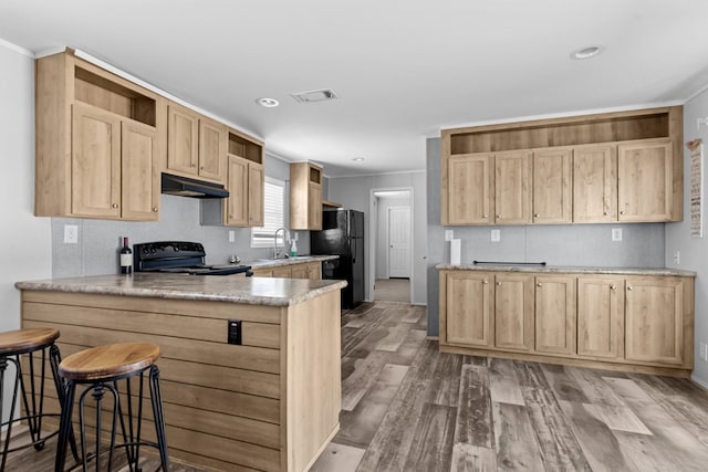 5714 Ector Ave, Odessa, TX 79714 - kitchen featuring open shelves, black appliances, under cabinet range hood, a peninsula, and light brown cabinets