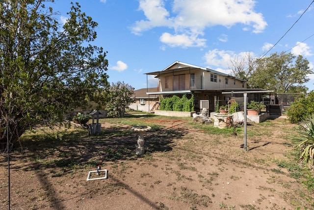 5714 Ector Ave, Odessa, TX 79714 - rear view of house featuring a sunroom