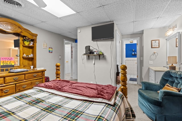 5714 Ector Ave, Odessa, TX 79714 - carpeted bedroom featuring a paneled ceiling, ensuite bathroom, and ceiling fan