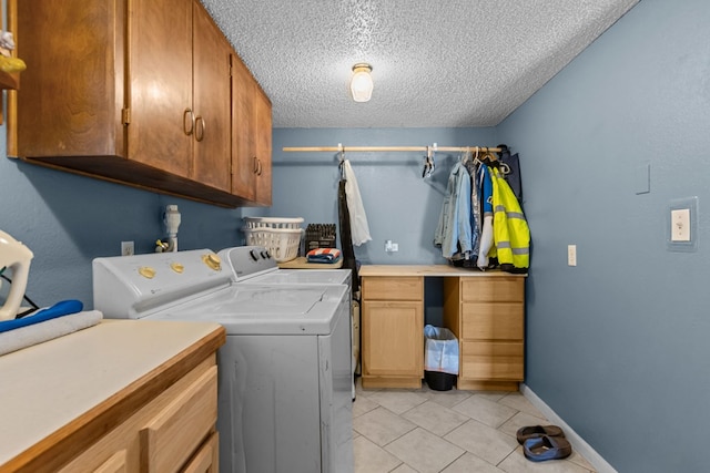 5714 Ector Ave, Odessa, TX 79714 - laundry area featuring cabinet space, washer and dryer, a textured ceiling, and light tile patterned flooring