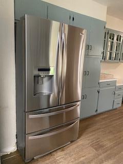 906 S Franklin Ave, Monahans, TX 79756 - kitchen view of stainless steel refrigerator with ice dispenser, light countertops, and light wood-style flooring