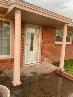 906 S Franklin Ave, Monahans, TX 79756 - doorway to property featuring brick siding