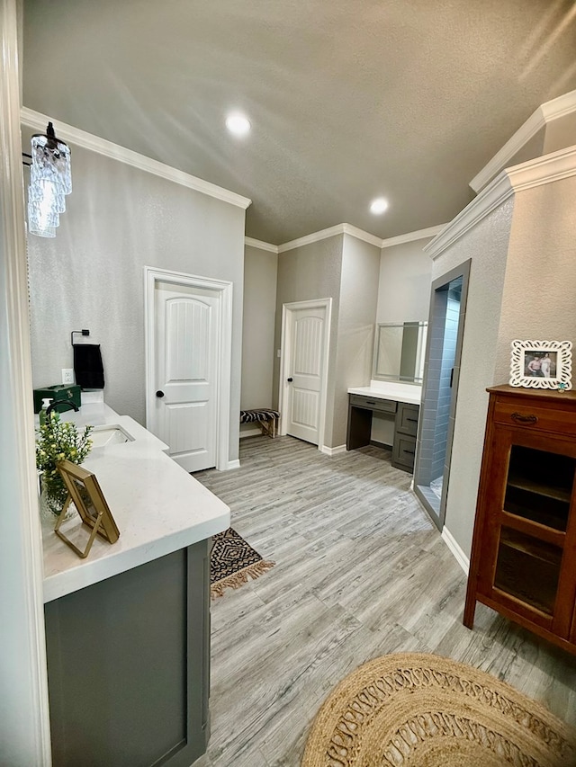 bathroom featuring a stall shower, recessed lighting, baseboards, crown molding, and wood finished floors