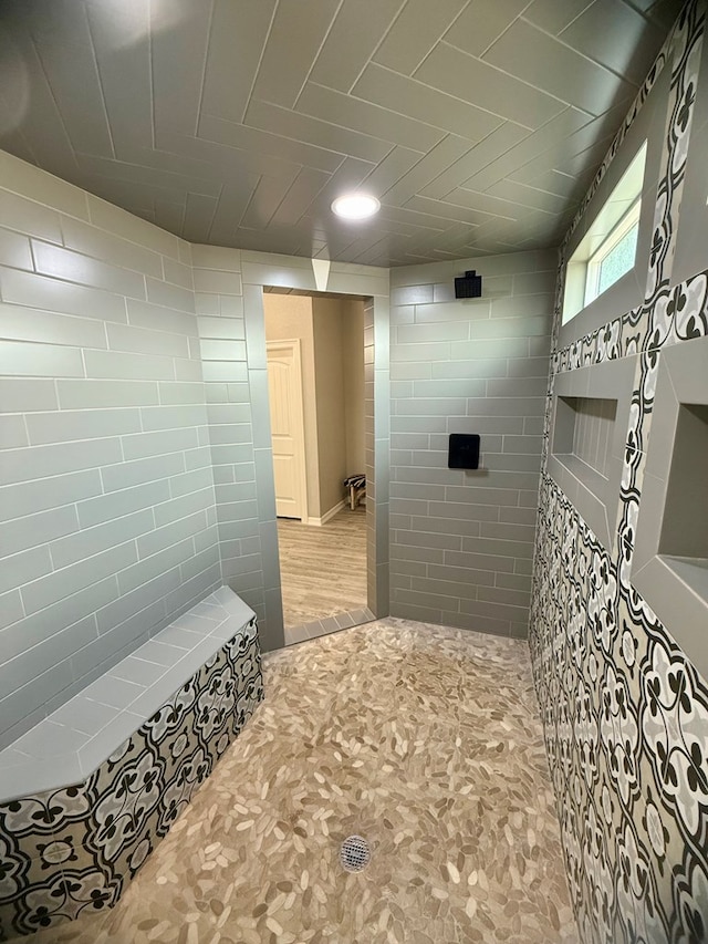 full bath featuring a tile shower