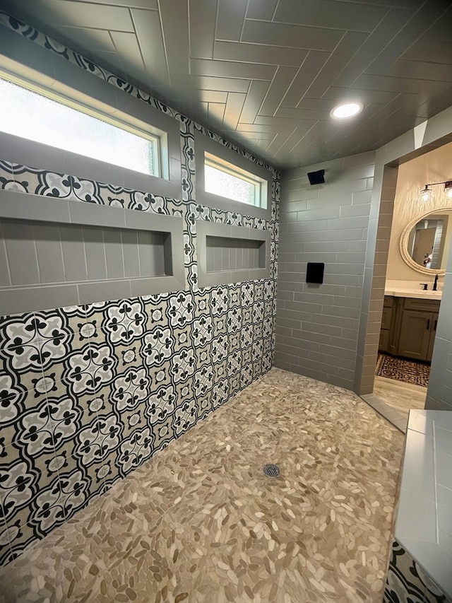 full bathroom featuring walk in shower and vanity