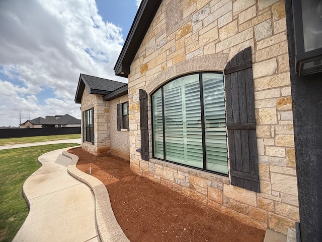 view of home's exterior featuring a yard and stone siding