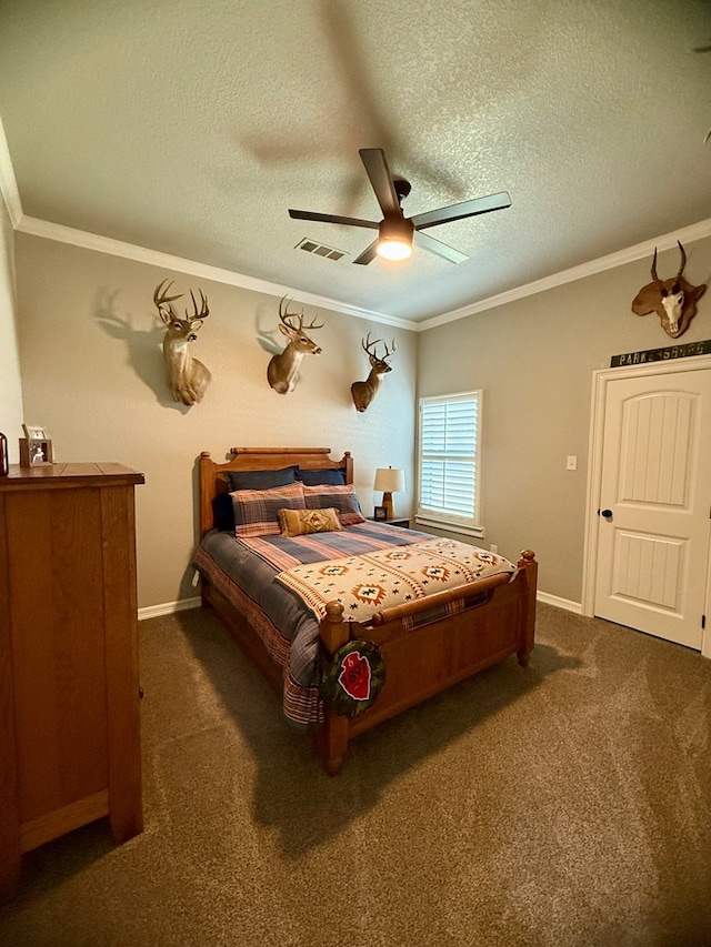 bedroom with crown molding, a textured ceiling, and dark colored carpet