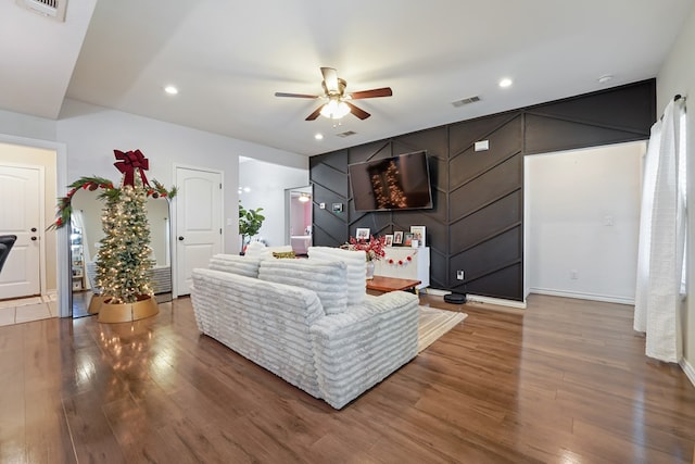 living room featuring hardwood / wood-style flooring and ceiling fan