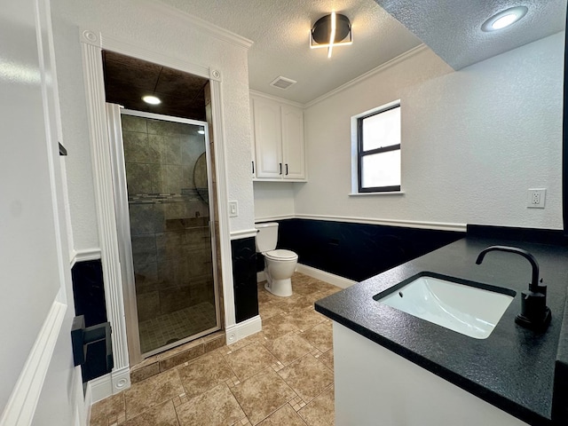 4612 Fountain Ln, Odessa, TX 79761 - full bathroom with vanity, crown molding, a stall shower, and a textured ceiling
