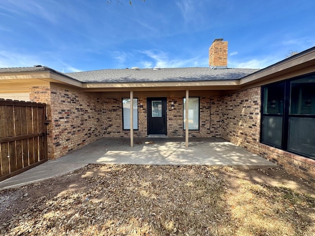 4612 Fountain Ln, Odessa, TX 79761 - entrance to property featuring brick siding, a patio area, and a chimney
