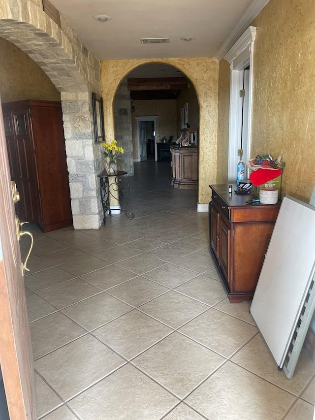 3934 N Bucknell Ave, Odessa, TX 79764 - corridor with arched walkways, light tile patterned floors, and a textured wall