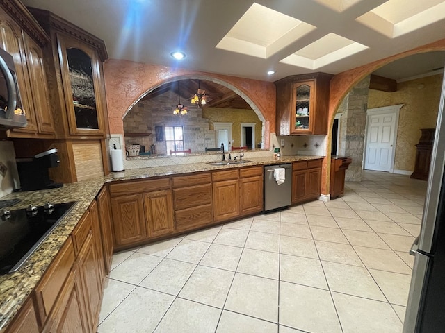 3934 N Bucknell Ave, Odessa, TX 79764 - kitchen featuring stainless steel appliances, a sink, arched walkways, brown cabinets, and recessed lighting