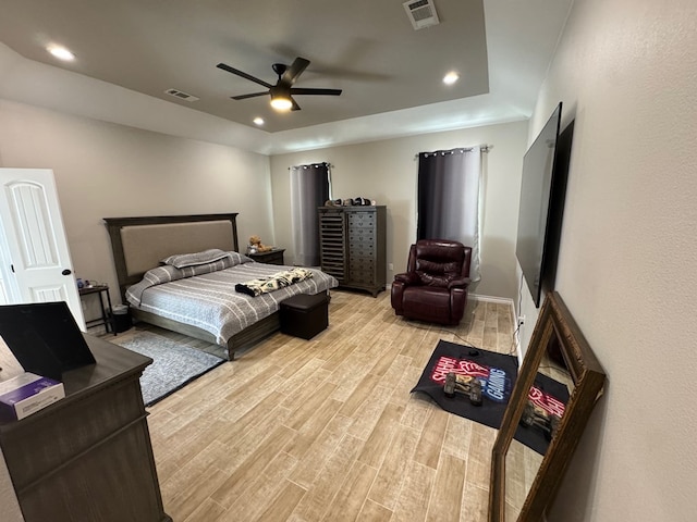1715 Morgan Way, Midland, TX 79705 - bedroom with light wood-style floors, recessed lighting, a ceiling fan, and a tray ceiling