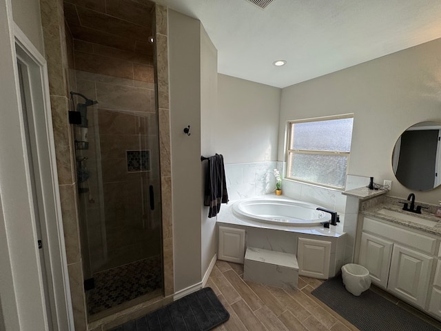 1715 Morgan Way, Midland, TX 79705 - bathroom featuring a stall shower, vanity, a bath, wood tiled floors, and recessed lighting