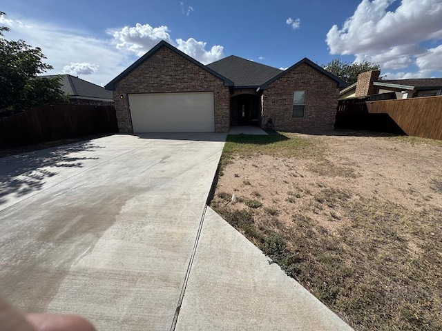1715 Morgan Way, Midland, TX 79705 - ranch-style house featuring brick siding, a garage, and driveway