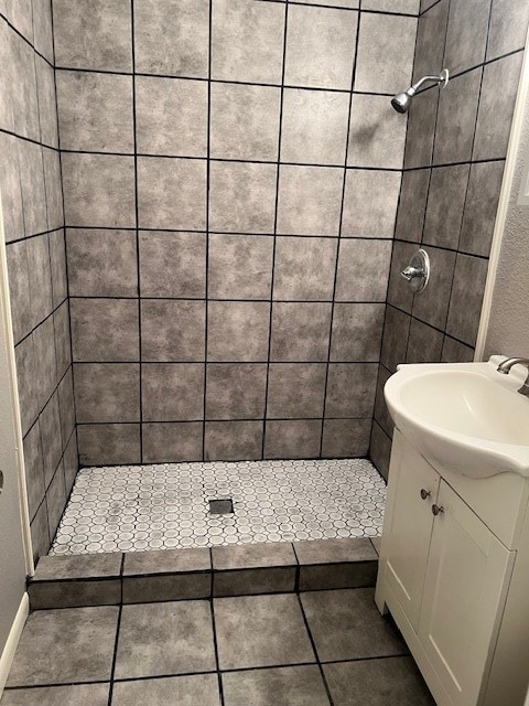 full bath with a shower stall, tile patterned flooring, and vanity