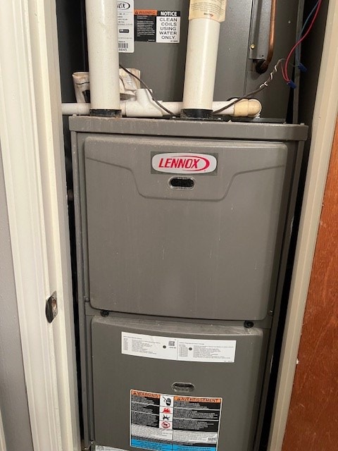 utility room featuring heating unit