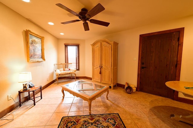 living area featuring ceiling fan and light tile patterned floors