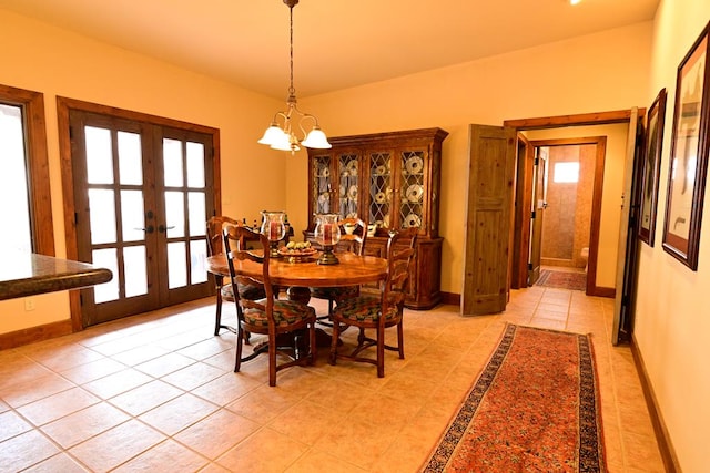 tiled dining area featuring french doors and a chandelier