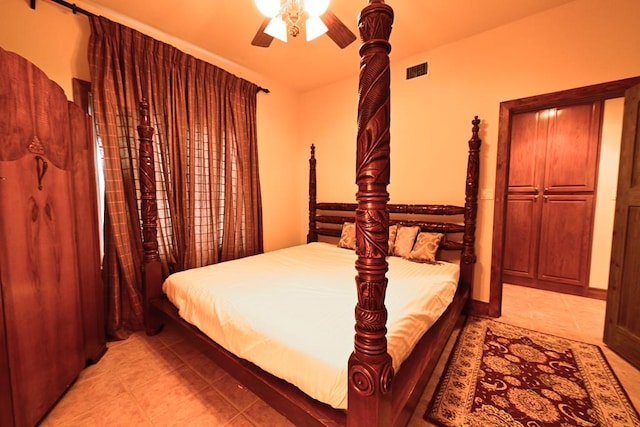 tiled bedroom with ceiling fan