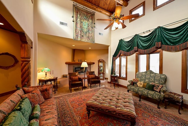 interior space featuring ceiling fan, wood ceiling, beamed ceiling, and a towering ceiling