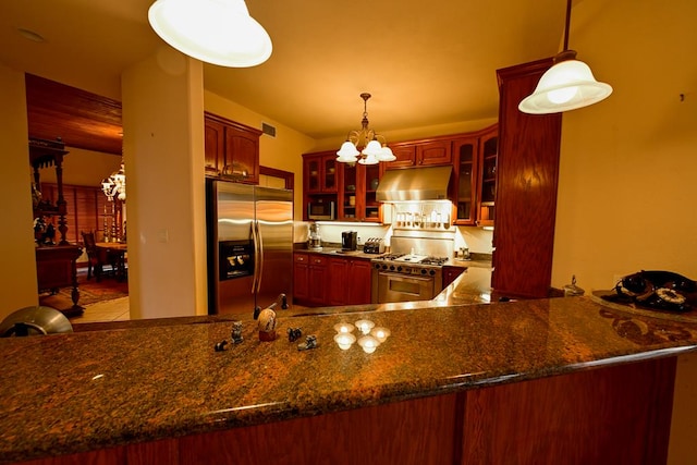 kitchen featuring pendant lighting, appliances with stainless steel finishes, exhaust hood, kitchen peninsula, and a chandelier