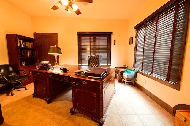 tiled home office featuring ceiling fan