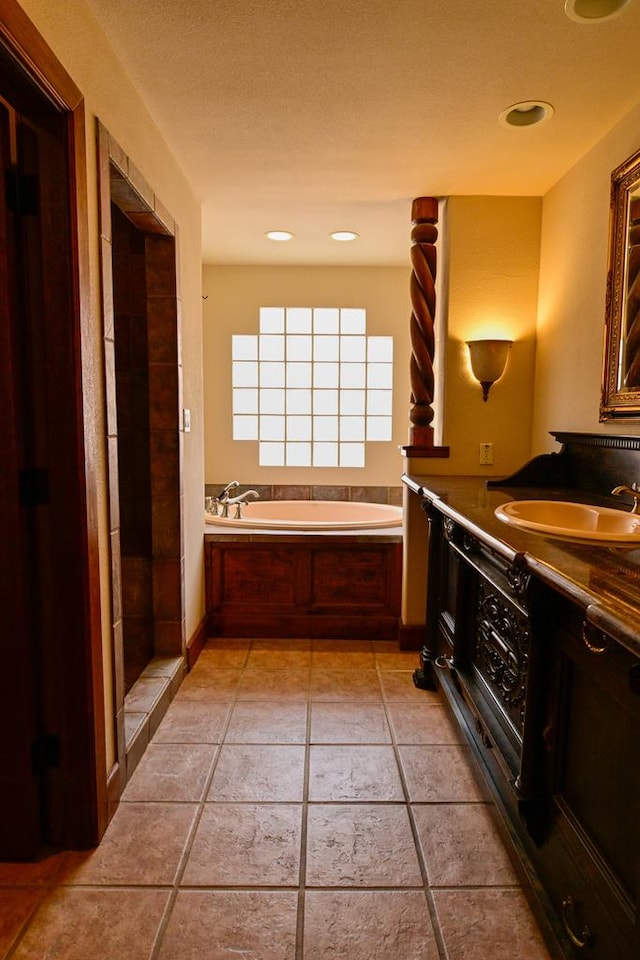 bathroom featuring vanity, independent shower and bath, and tile patterned floors