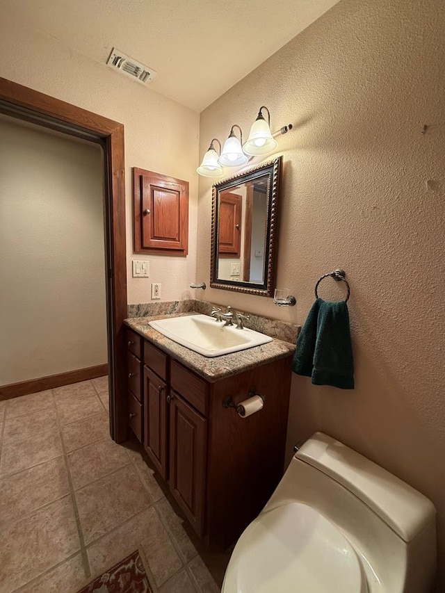 bathroom featuring toilet and vanity