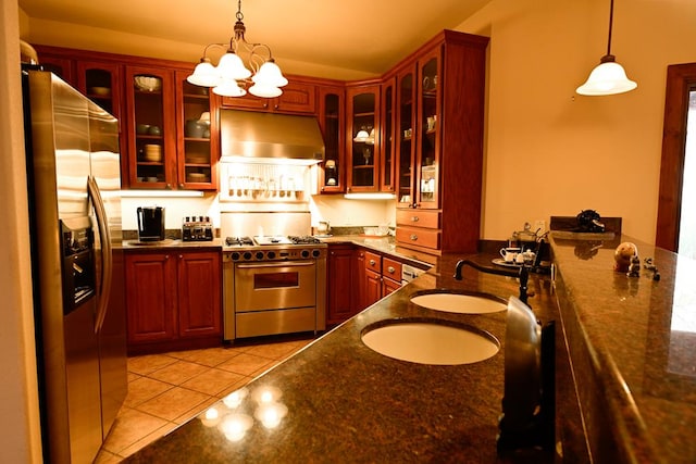 kitchen with hanging light fixtures, appliances with stainless steel finishes, ventilation hood, and light tile patterned flooring