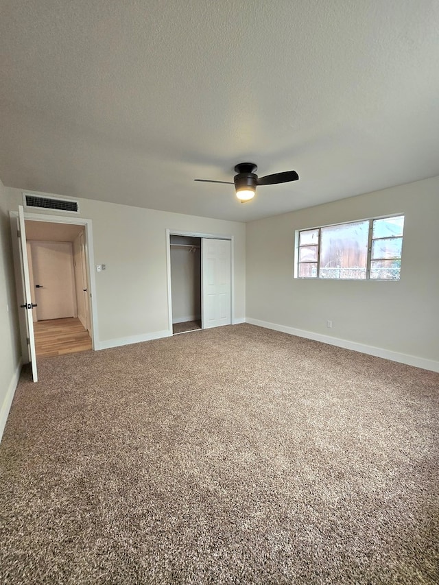 2500 Roper St, Odessa, TX 79761 - unfurnished bedroom with carpet flooring, a closet, a textured ceiling, and a ceiling fan