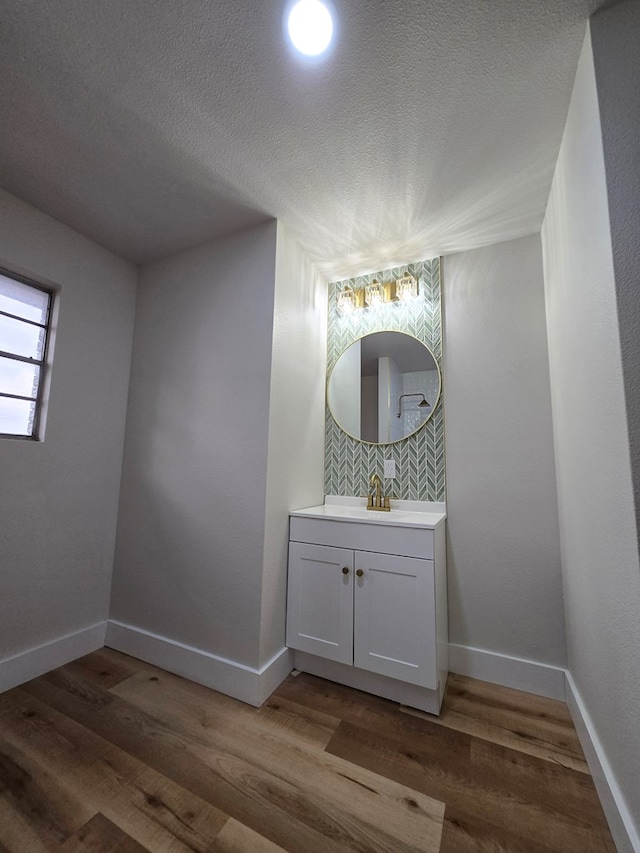 2500 Roper St, Odessa, TX 79761 - bathroom featuring vanity, wood finished floors, and a textured ceiling