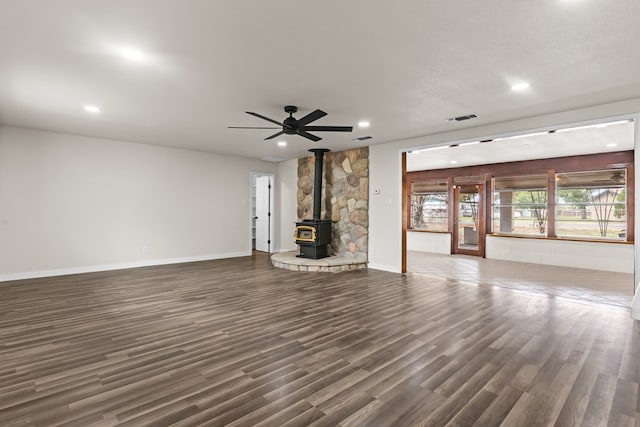 622 W Hillmont Rd, Odessa, TX 79764 - unfurnished living room with a wood stove, dark wood-style flooring, recessed lighting, and ceiling fan