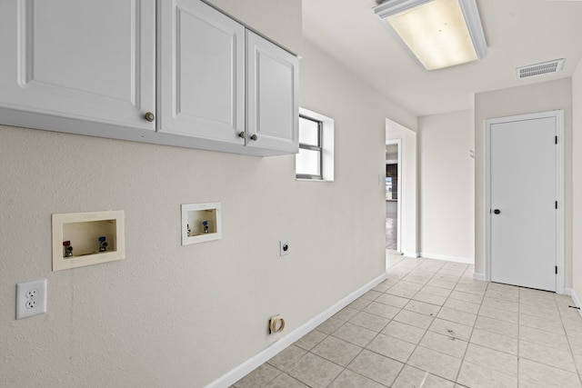 622 W Hillmont Rd, Odessa, TX 79764 - washroom featuring hookup for a washing machine, electric dryer hookup, cabinet space, and light tile patterned floors