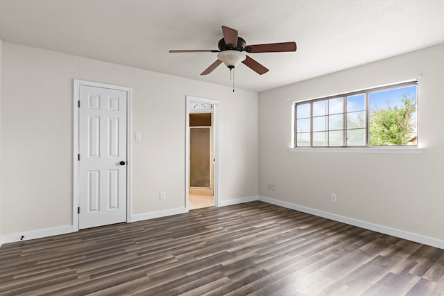 622 W Hillmont Rd, Odessa, TX 79764 - unfurnished bedroom featuring dark wood-style floors, ensuite bath, and ceiling fan