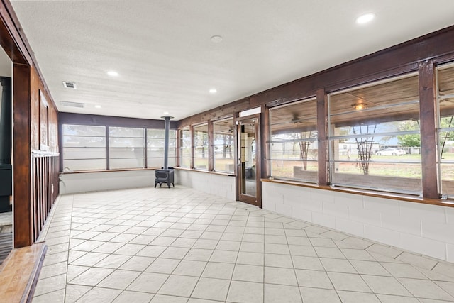 622 W Hillmont Rd, Odessa, TX 79764 - unfurnished sunroom featuring a wood stove, recessed lighting, and a textured ceiling