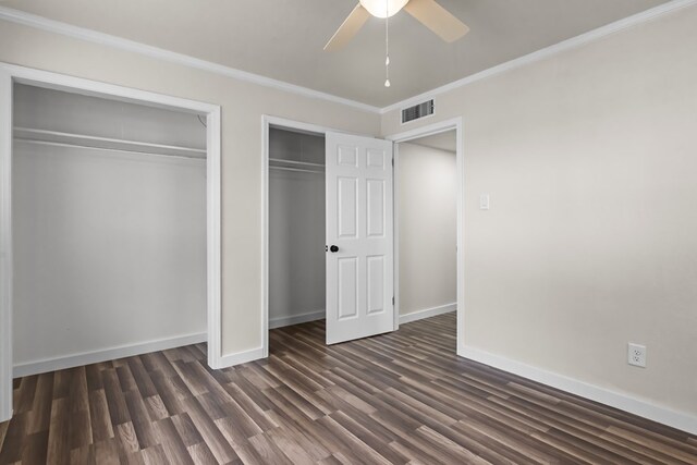 622 W Hillmont Rd, Odessa, TX 79764 - unfurnished bedroom featuring dark wood-style floors, ornamental molding, two closets, and a ceiling fan