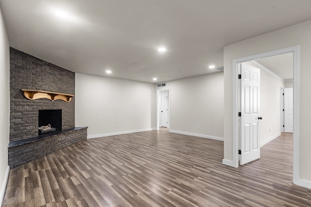 622 W Hillmont Rd, Odessa, TX 79764 - unfurnished living room featuring recessed lighting, wood finished floors, and a brick fireplace