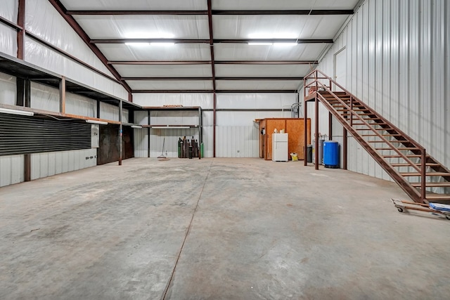 7101 W County Rd 44, Midland, TX 79707 - garage with freestanding refrigerator and metal wall