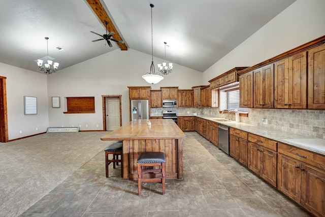 7101 W County Rd 44, Midland, TX 79707 - kitchen with appliances with stainless steel finishes, a chandelier, high vaulted ceiling, brown cabinets, and ceiling fan