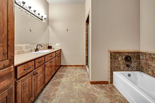 7101 W County Rd 44, Midland, TX 79707 - bathroom with vanity, a garden tub, baseboards, and tasteful backsplash