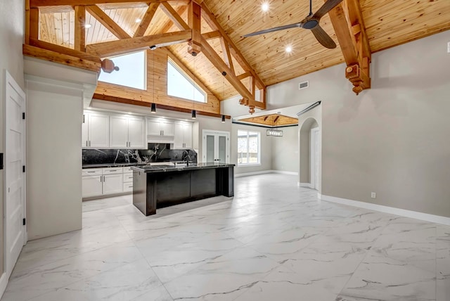 8634 Luz Dr, Odessa, TX 79765 - kitchen with wooden ceiling with exposed beams, dark countertops, open floor plan, high vaulted ceiling, and white cabinets