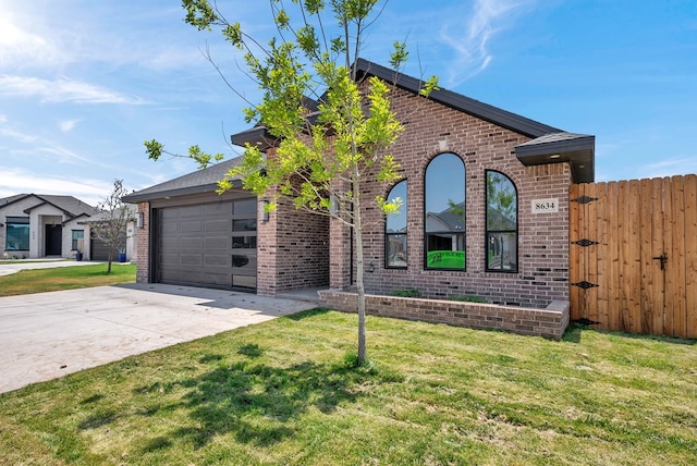 8634 Luz Dr, Odessa, TX 79765 - view of front of property with driveway, brick siding, a garage, and a gate