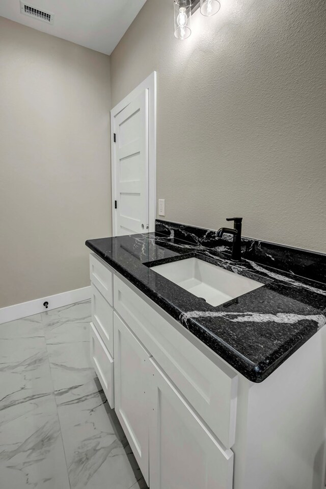 8634 Luz Dr, Odessa, TX 79765 - bathroom featuring vanity and marble look tiles