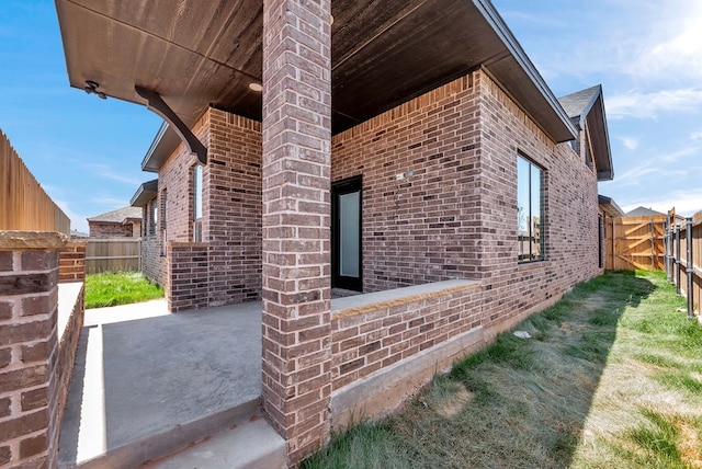 8634 Luz Dr, Odessa, TX 79765 - view of property exterior featuring brick siding and a patio area