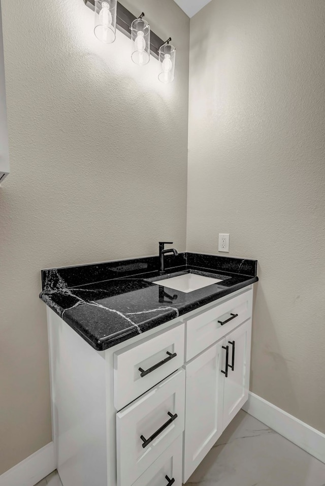 8634 Luz Dr, Odessa, TX 79765 - bathroom featuring vanity, baseboards, and marble finish floors