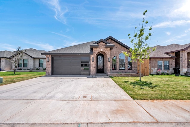 8634 Luz Dr, Odessa, TX 79765 - french country inspired facade with brick siding, a front lawn, and driveway