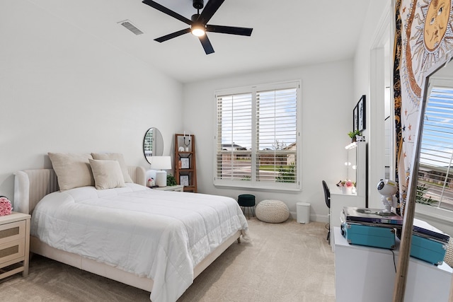 bedroom with ceiling fan and light colored carpet