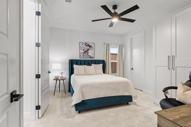 bedroom with light colored carpet and ceiling fan