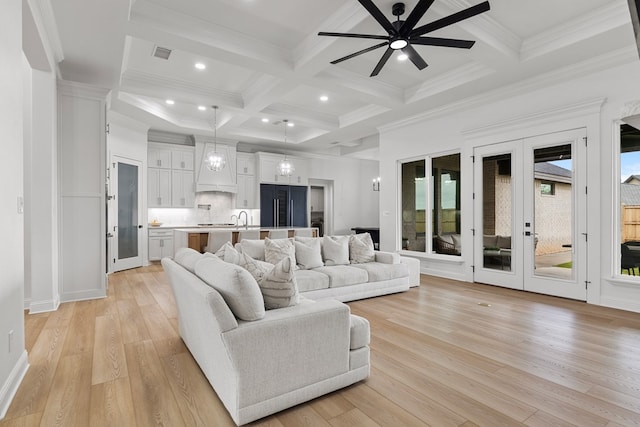 living room featuring beamed ceiling, ceiling fan, french doors, and light hardwood / wood-style flooring